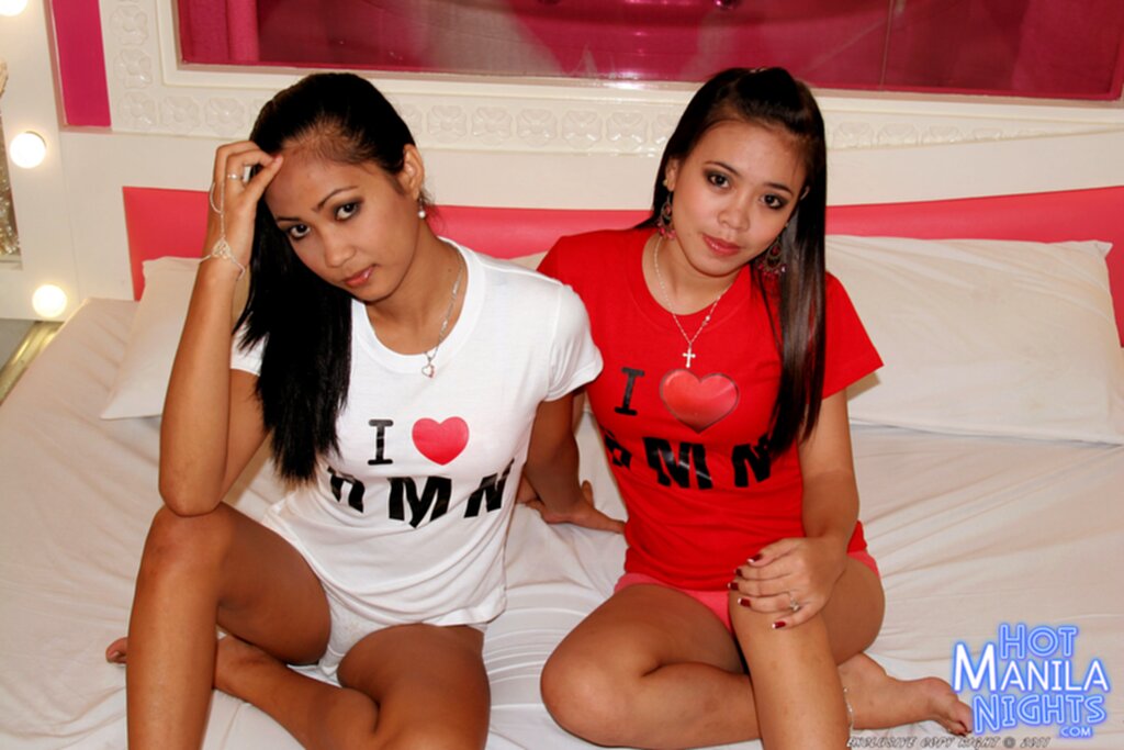 Seated together on bed long hair wearing tshirts flashing panties